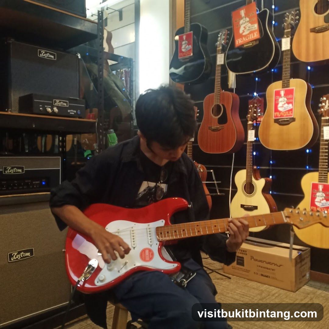 Man playing a red electric guitar in a music store