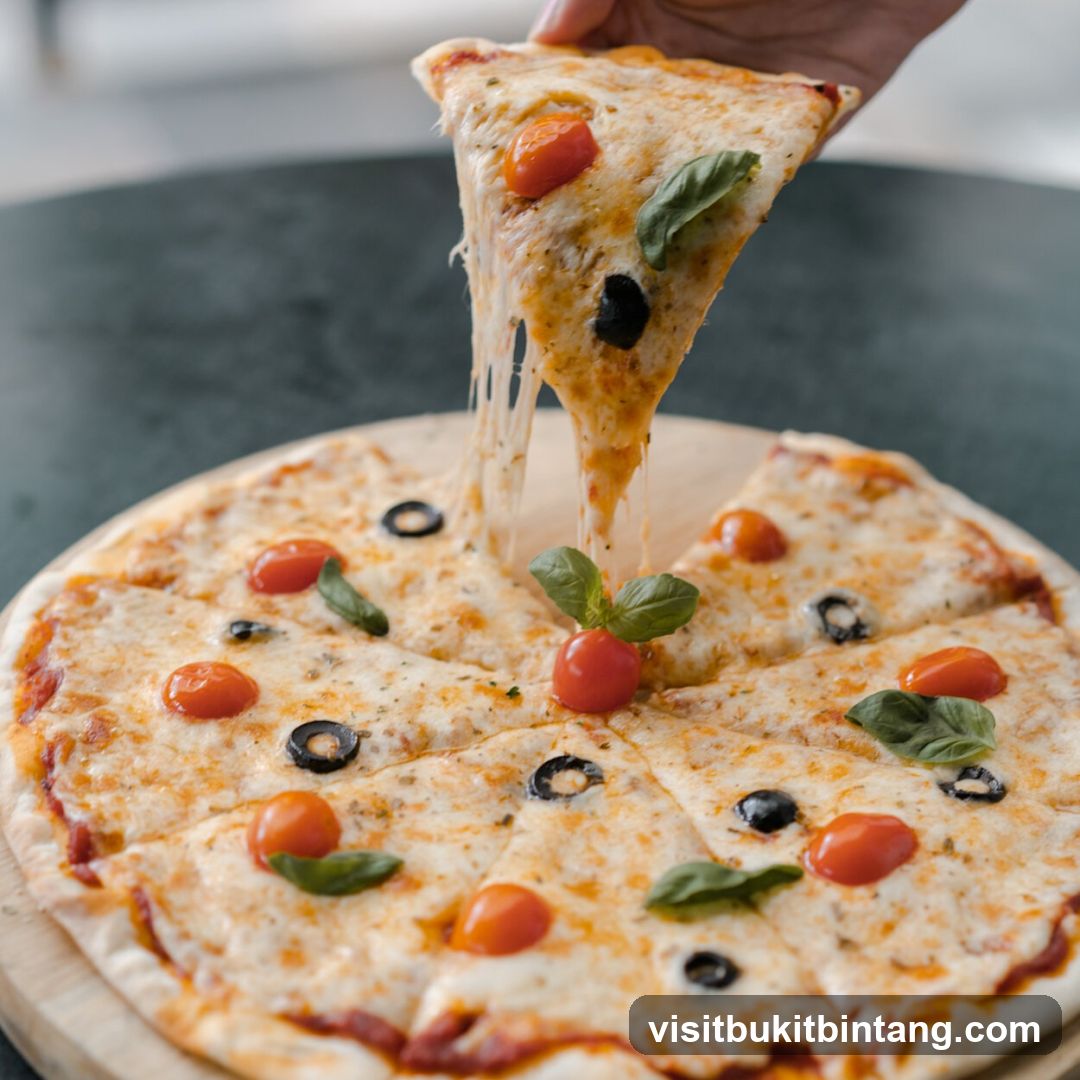 Pizza Slice Being Lifted