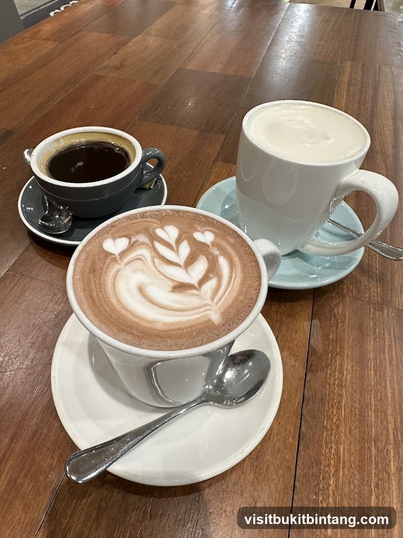 Three coffee drinks on a wooden table