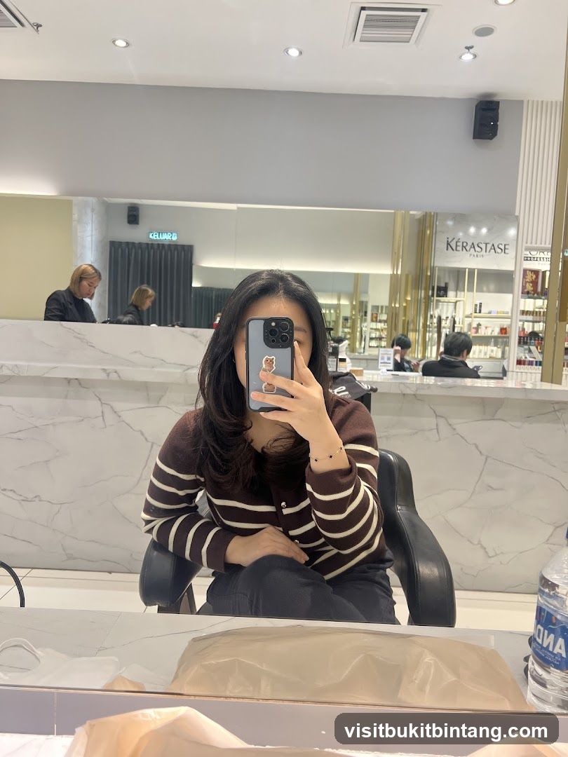 Woman taking a mirror selfie in a salon
