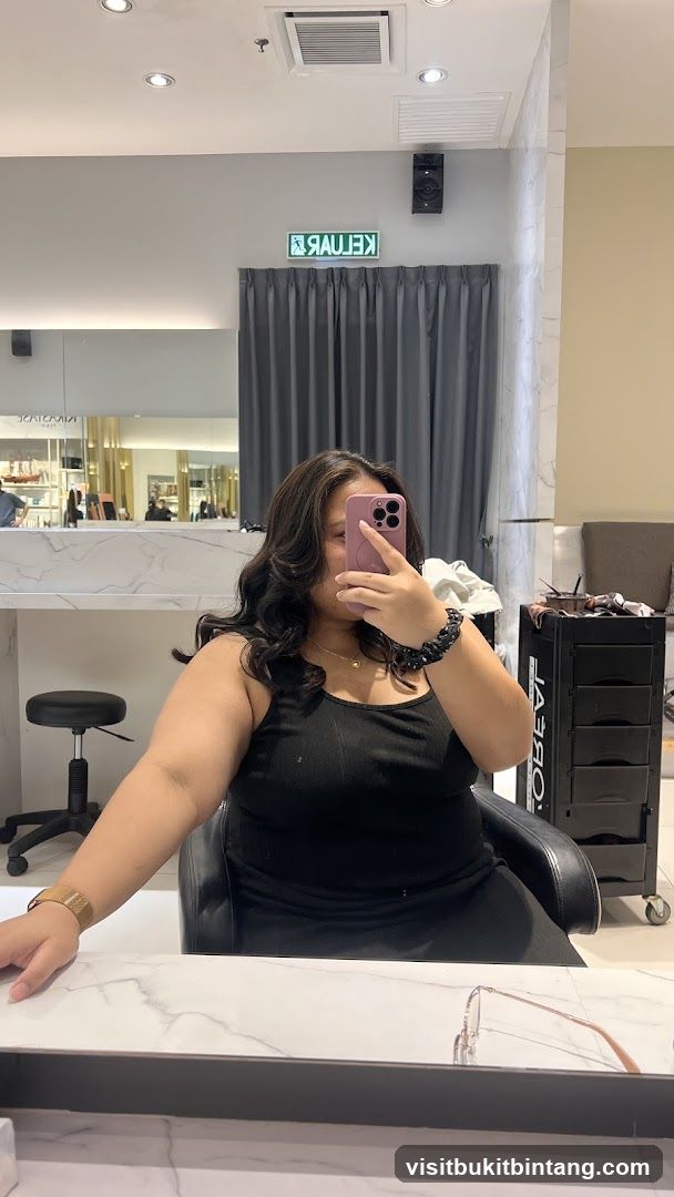 Woman taking a selfie in a salon