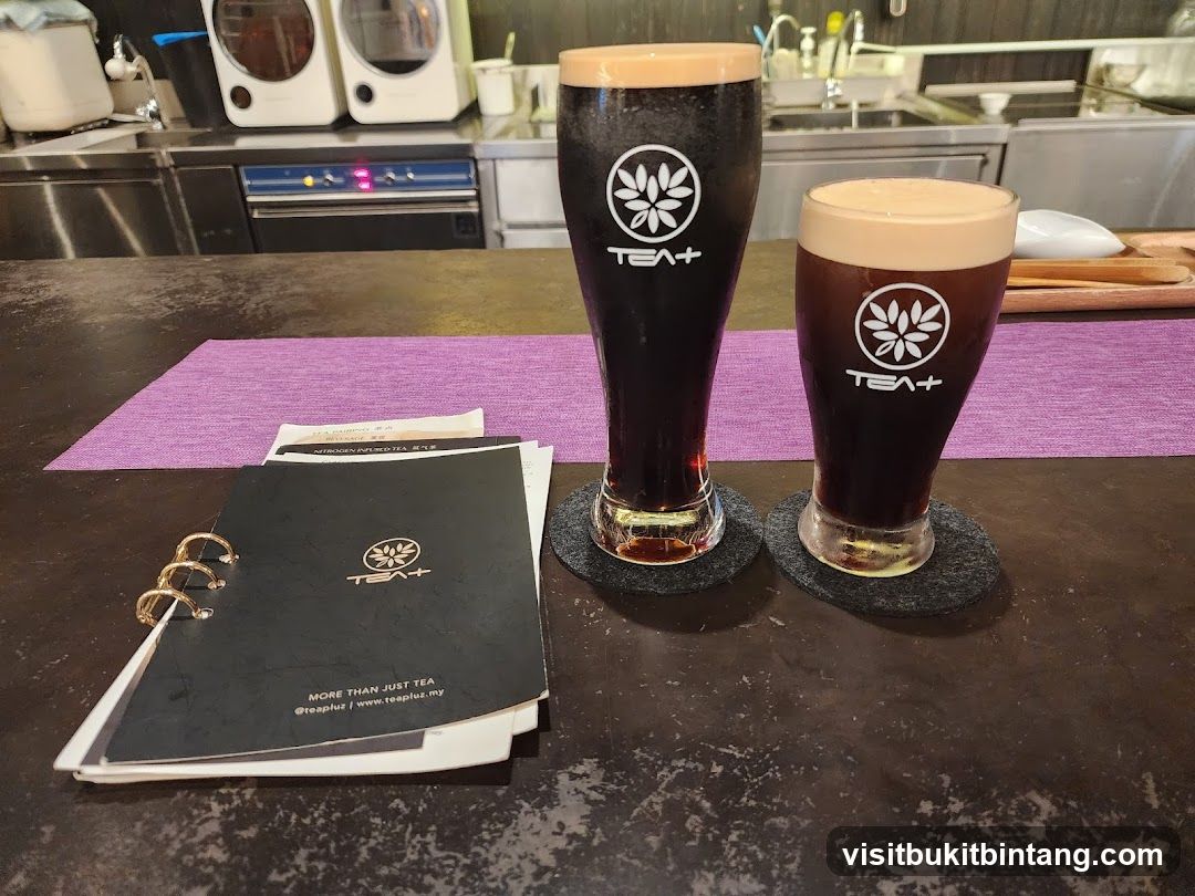 Two dark beverages with foam tops