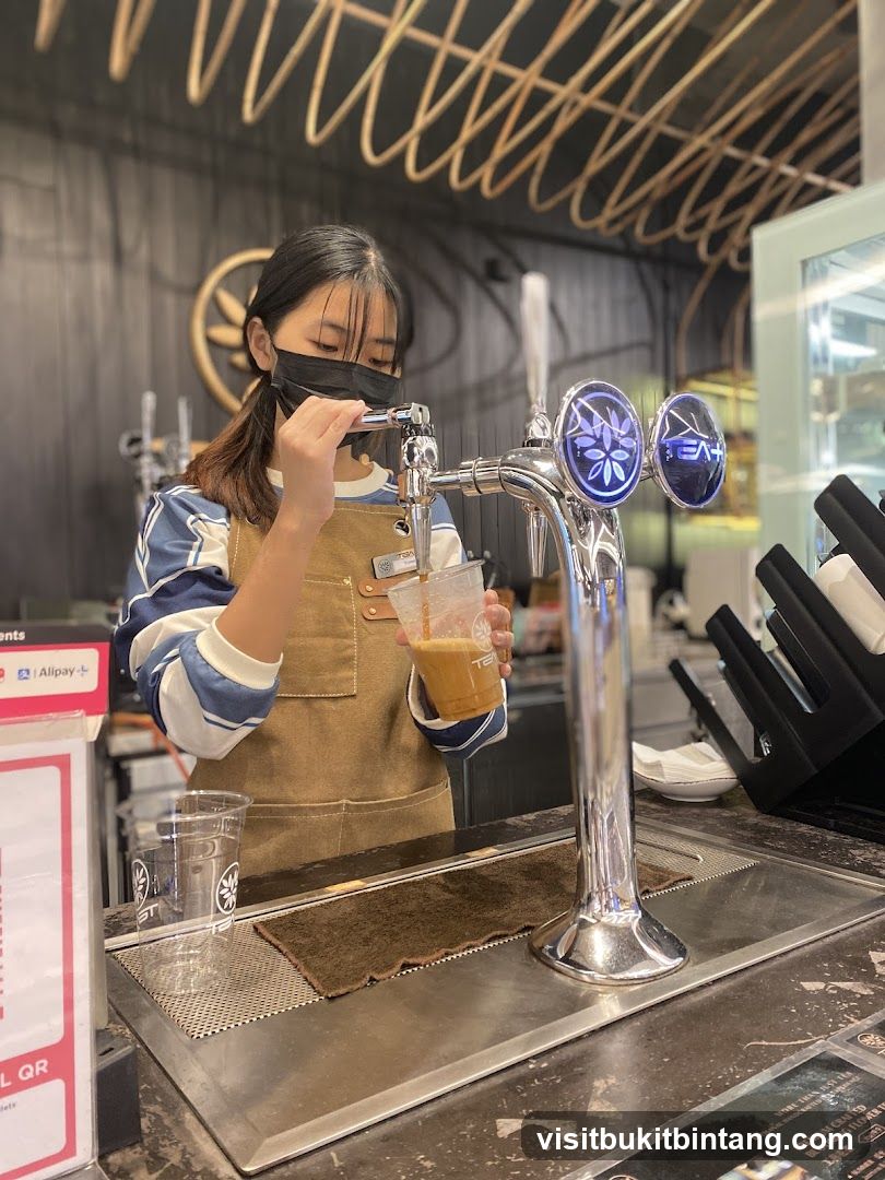 Barista pouring a drink