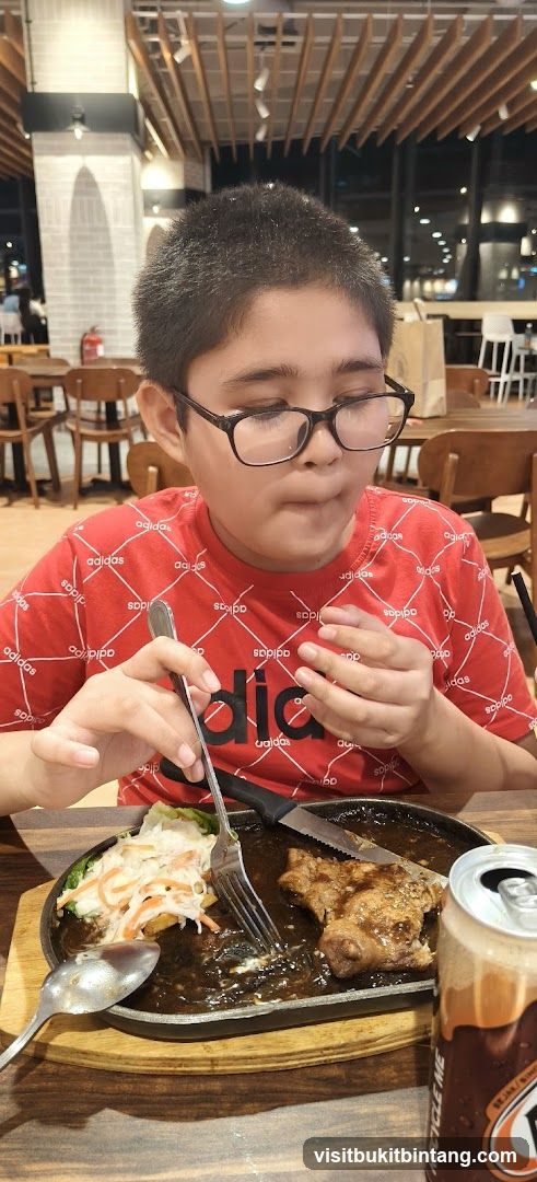 Boy eating steak