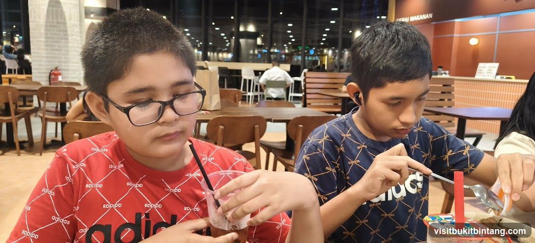 Two boys eating at a restaurant