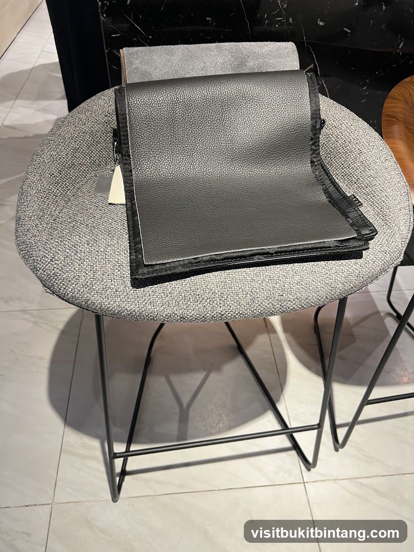 Folded Black Leather Item on Stool