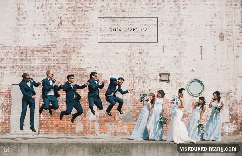 Wedding Party Posing Against Brick Wall