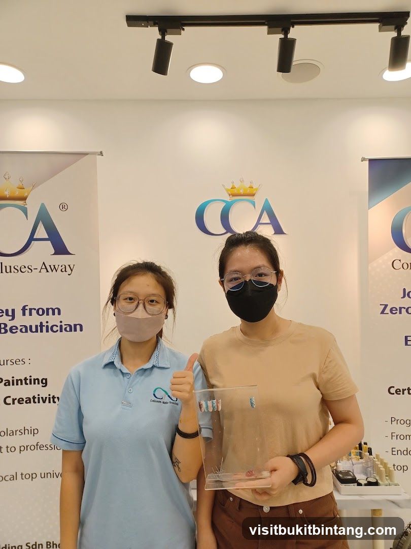 Two women posing with nail art samples