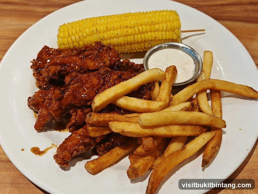 Chicken tenders with fries and corn on the cob