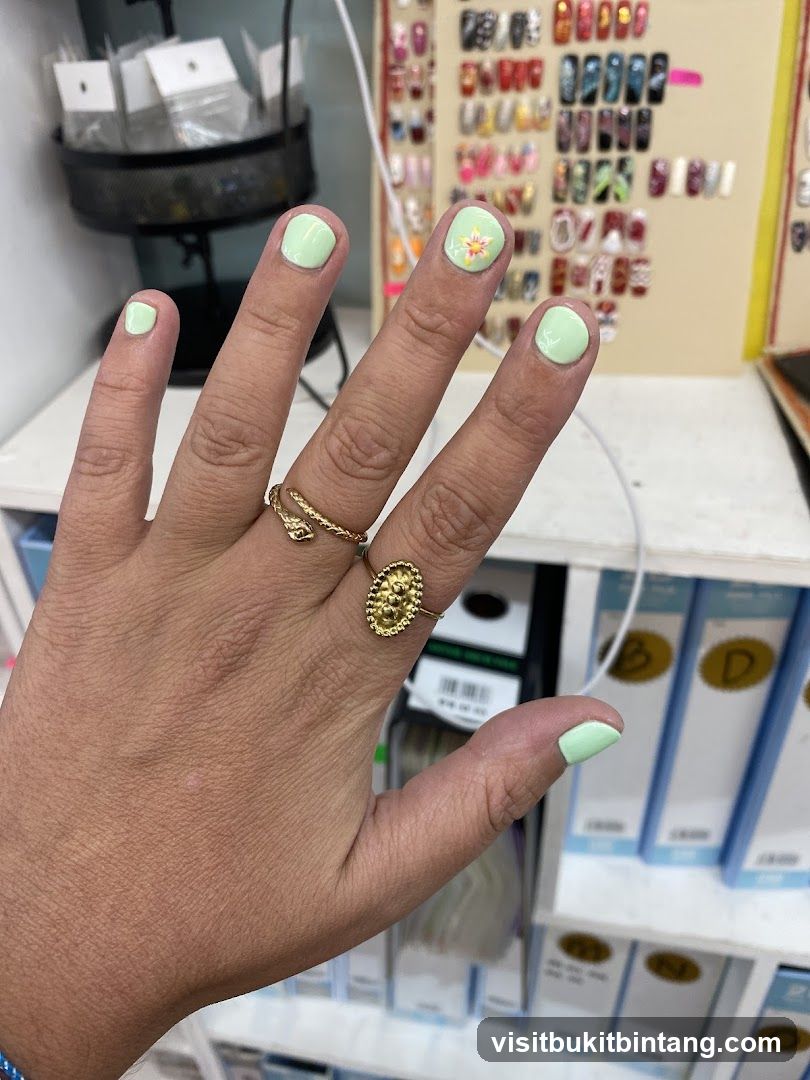 Light Green Nails with Flower Accent