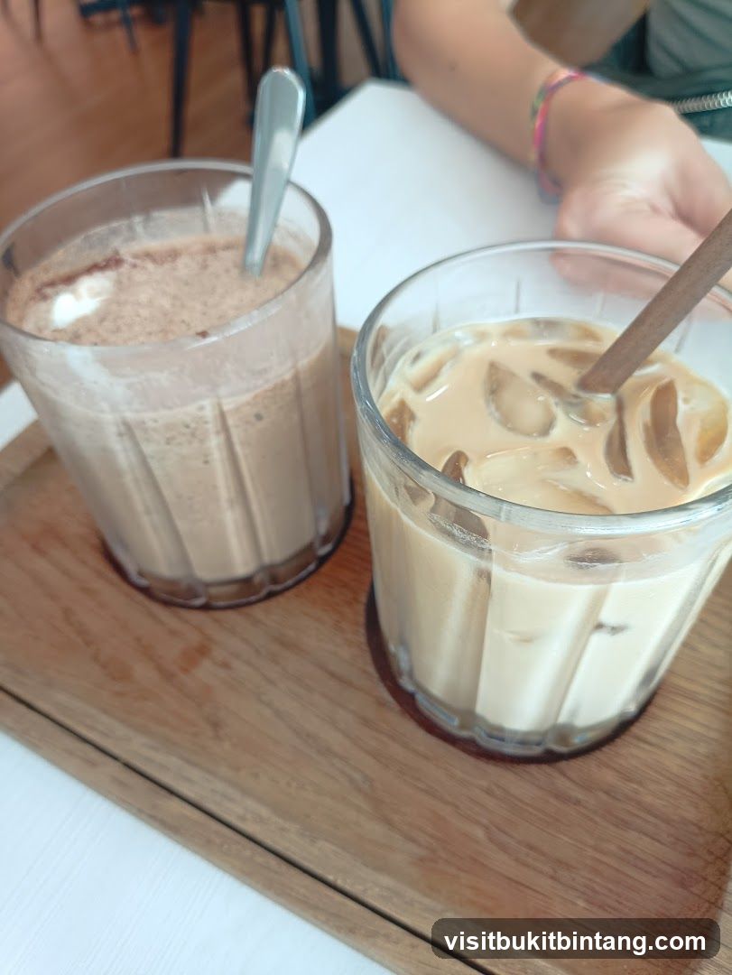 Two iced drinks on a wooden tray