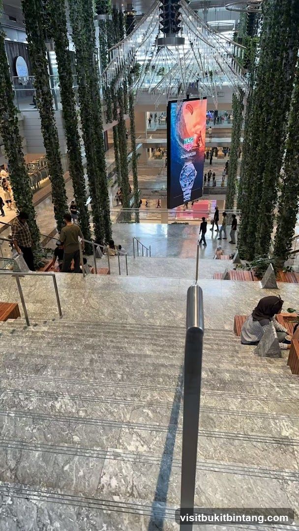 Indoor mall with greenery and digital advertisement