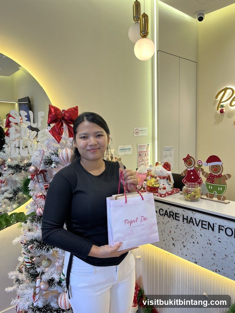 Woman holding a gift bag in front of a Christmas tree