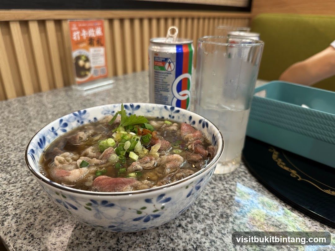 Beef noodle soup with a can of soda