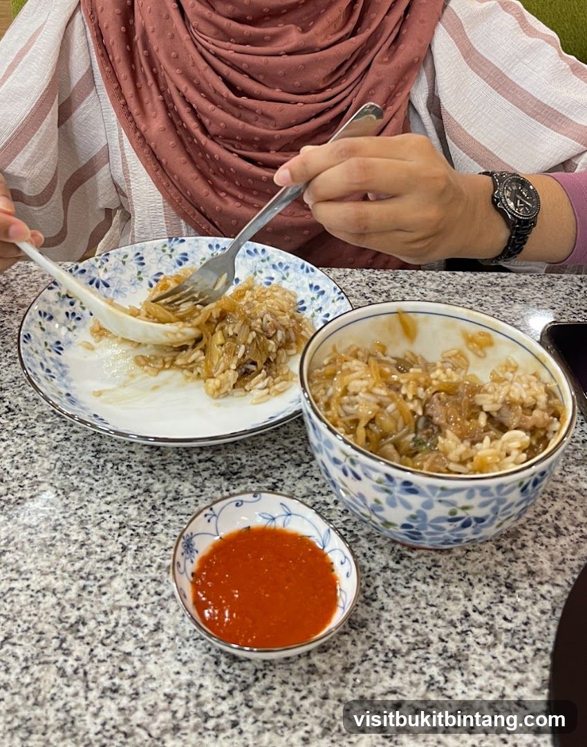 Person eating rice dish