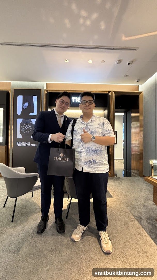 Two men posing in a watch store