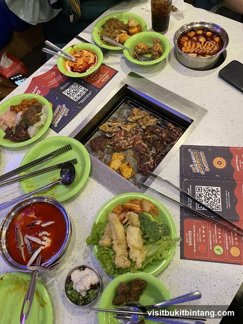 Table with Korean BBQ and various dishes