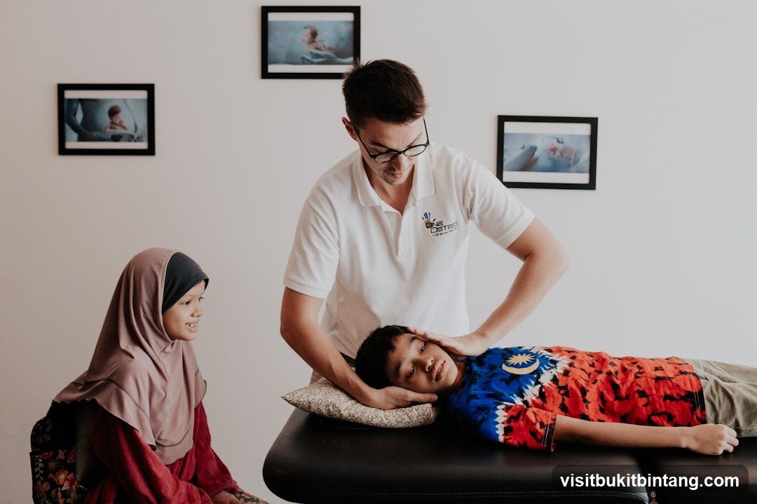 Chiropractor adjusting a young patient