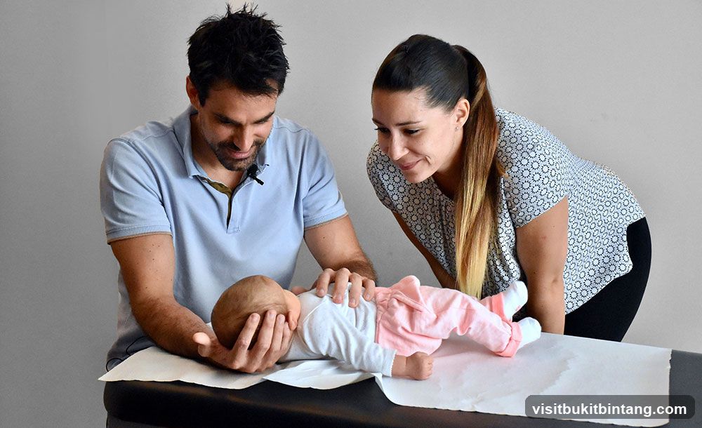 People practicing infant care