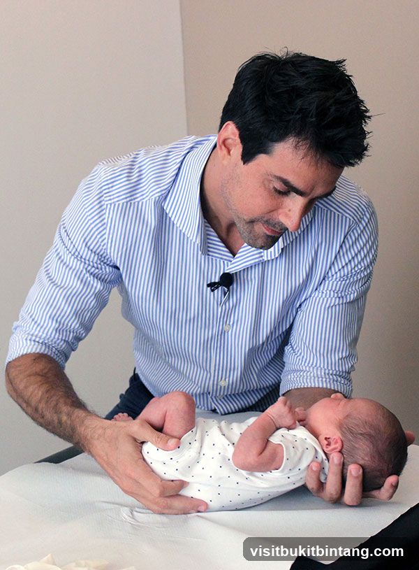 Chiropractor examining a baby