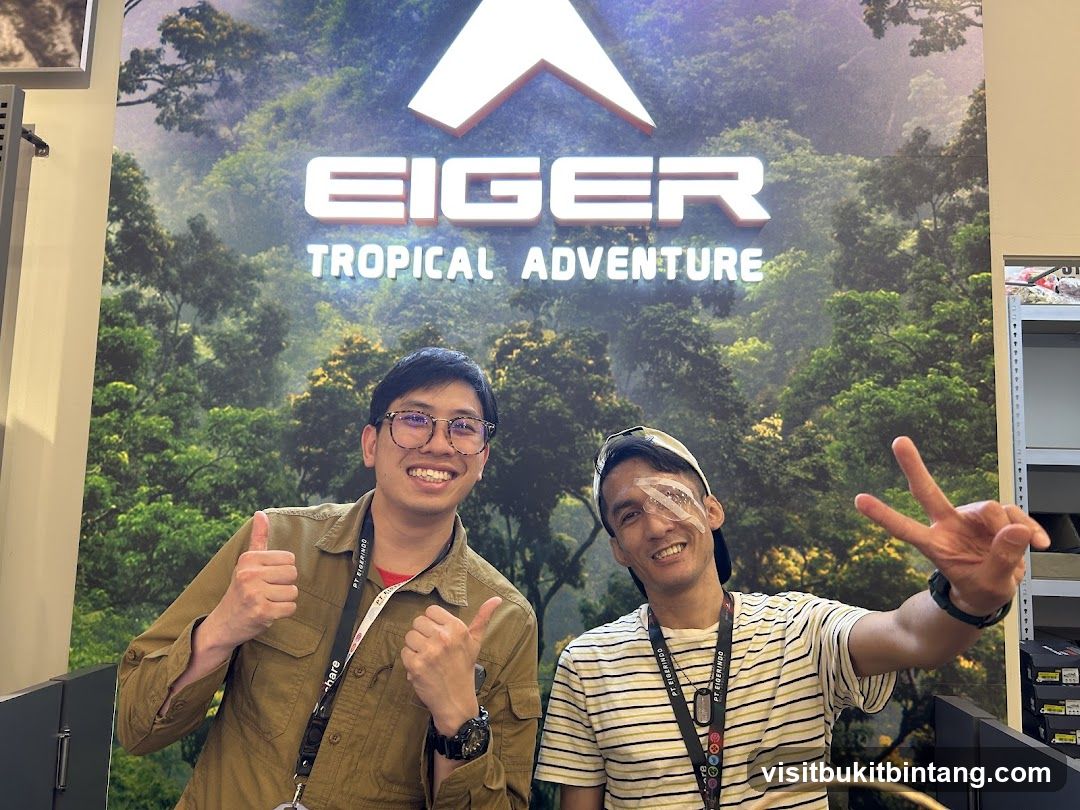 Two men posing in front of an Eiger Tropical Adventure backdrop