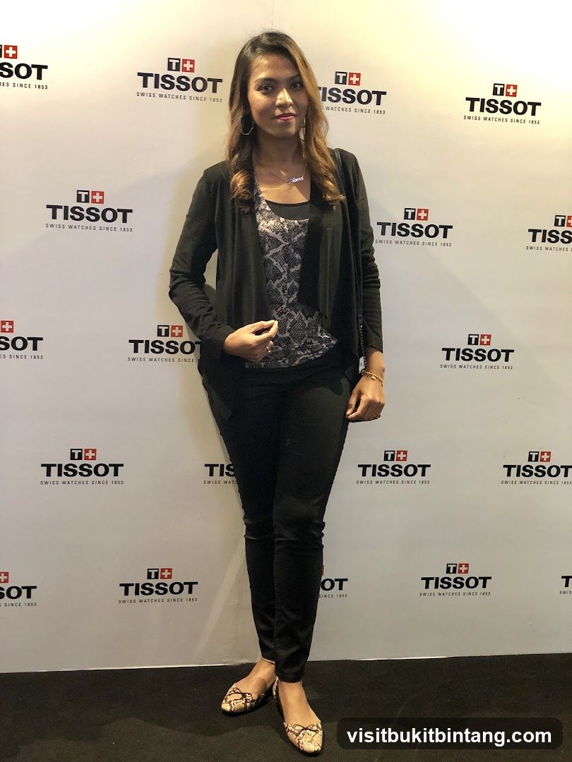 Woman Posing in front of Tissot Logo Wall