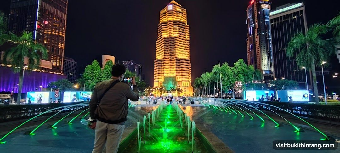 Nighttime cityscape with illuminated fountain