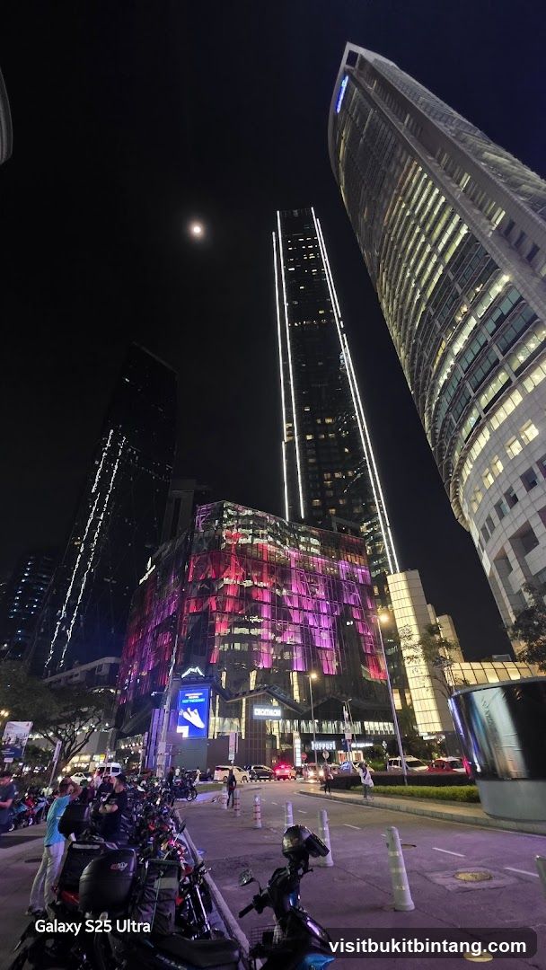 Cityscape at Night with Illuminated Buildings and Motorcycles