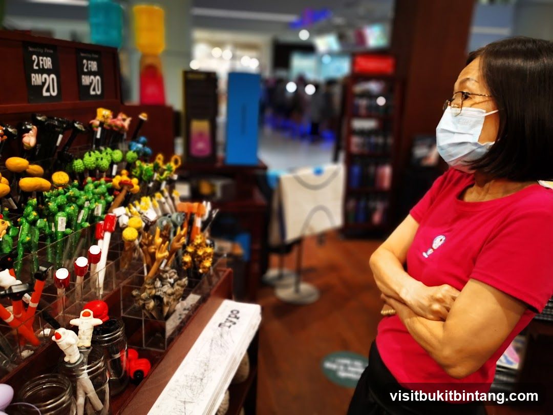 Woman in a store looking at novelty pens