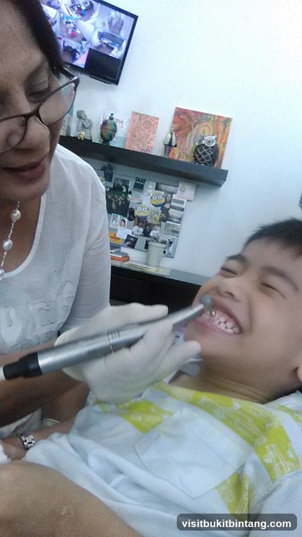 Dentist cleaning a child's teeth