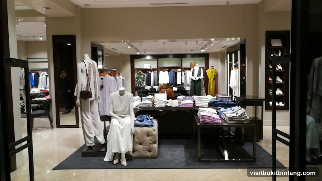 Clothing store interior with mannequins and folded apparel