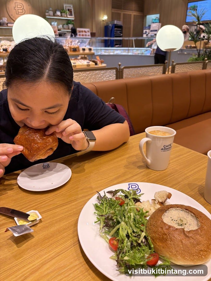 Woman Eating Pastry at Cafe