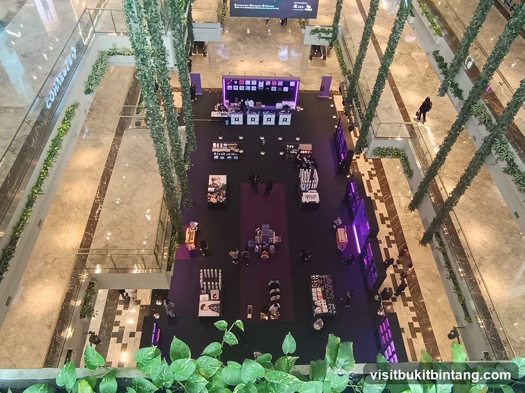 Indoor shopping mall with greenery and pop-up stalls