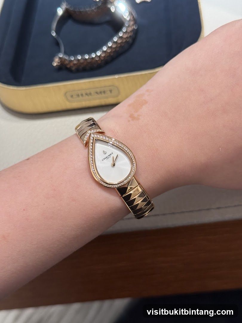 Woman wearing a diamond-encrusted pear-shaped watch