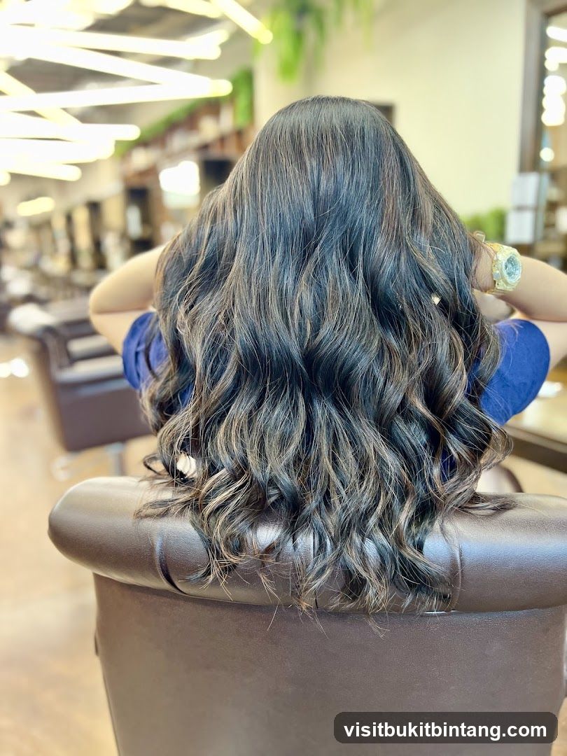 Woman with long, wavy, highlighted hair
