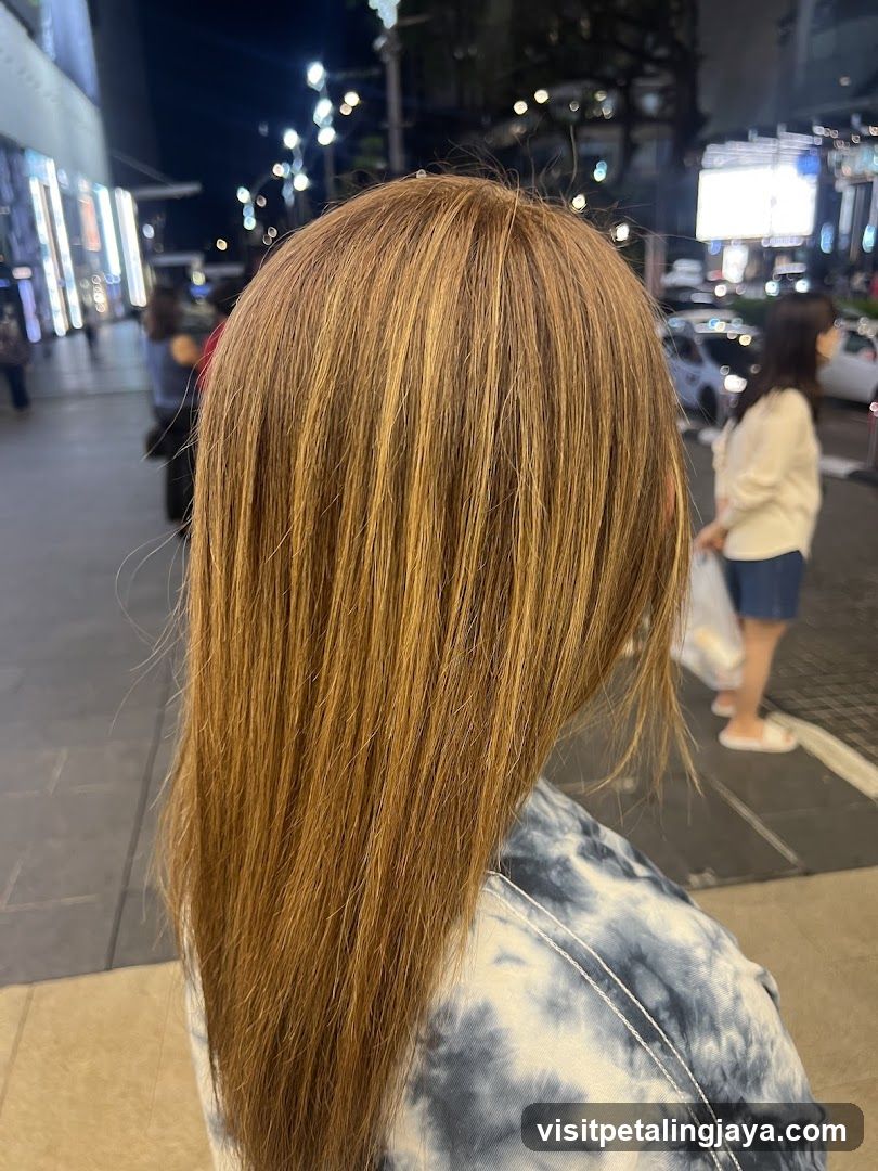 Back of a person with long hair at night