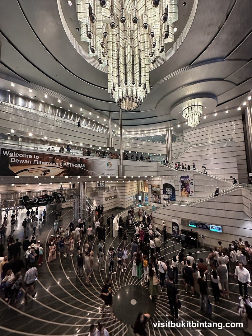 Interior of a large, modern building with a grand chandelier