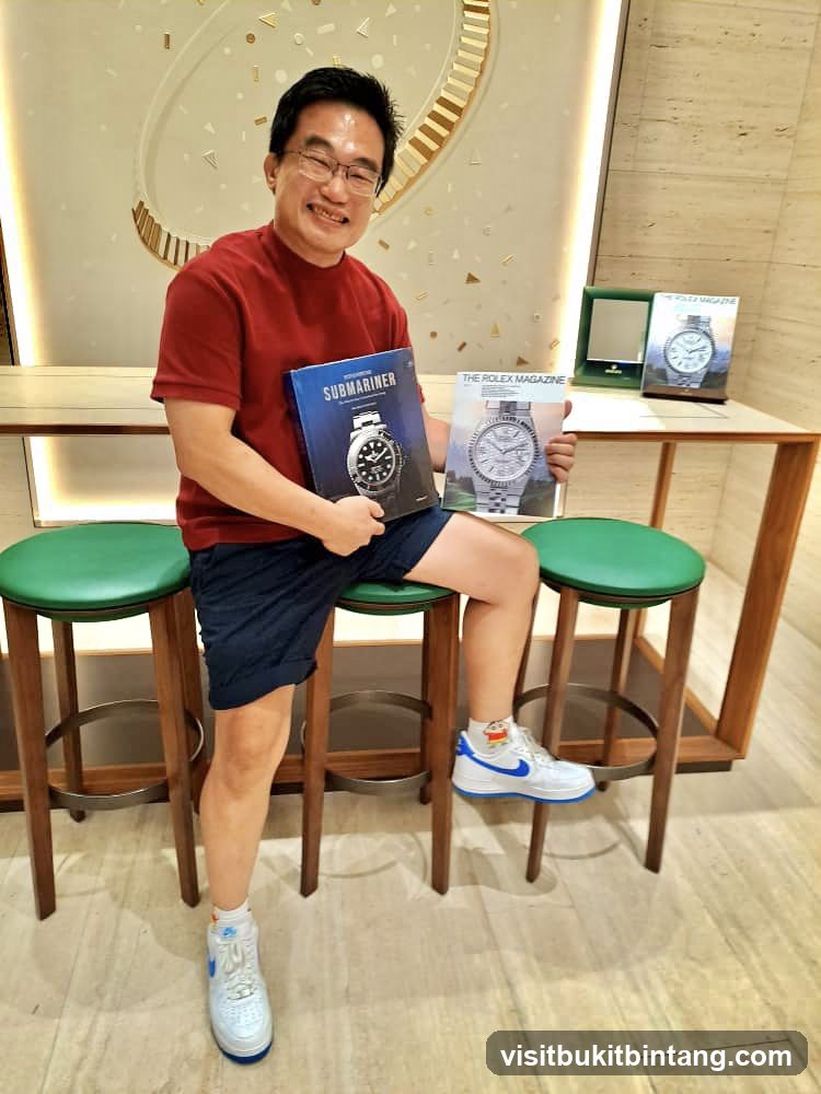 Man holding Rolex magazines