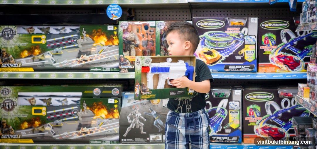 Boy Holding Toy Gun in Toy Store