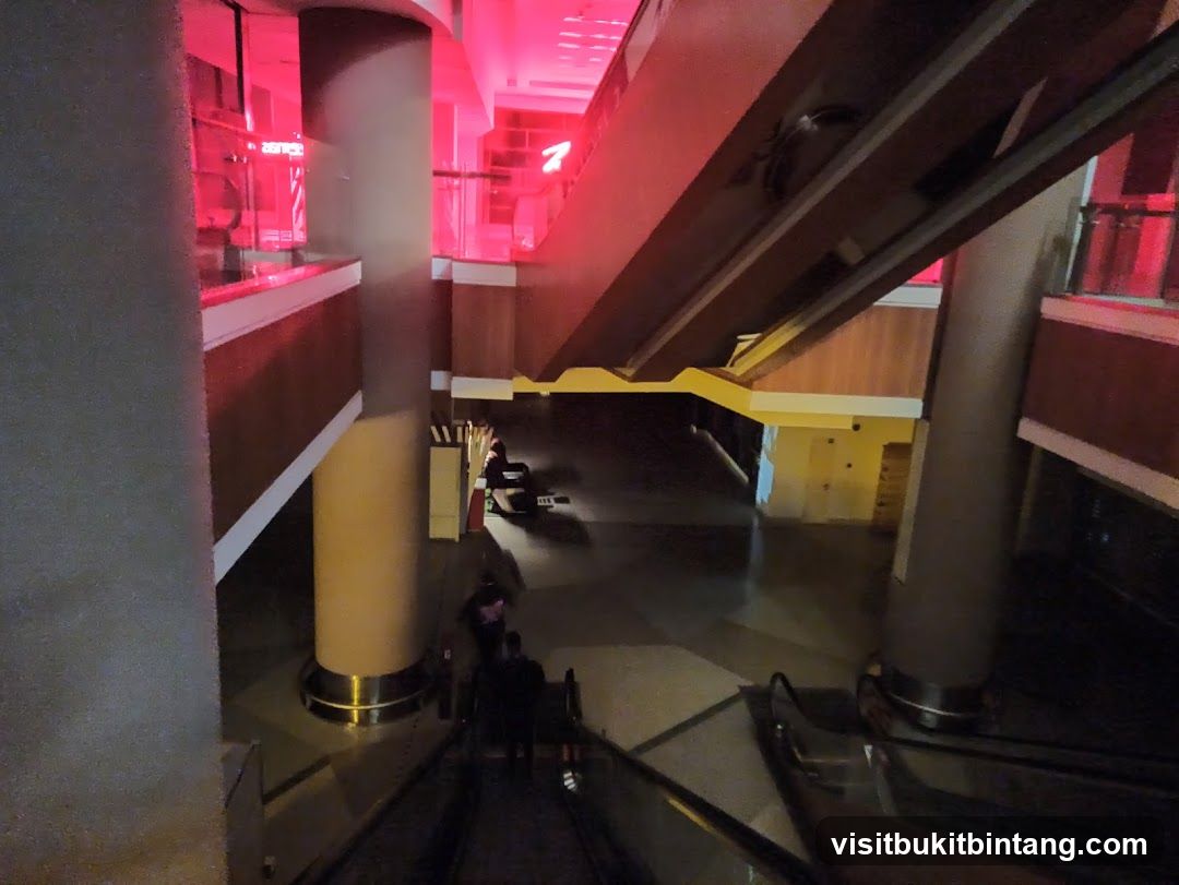 Interior of a building with escalators and red lighting