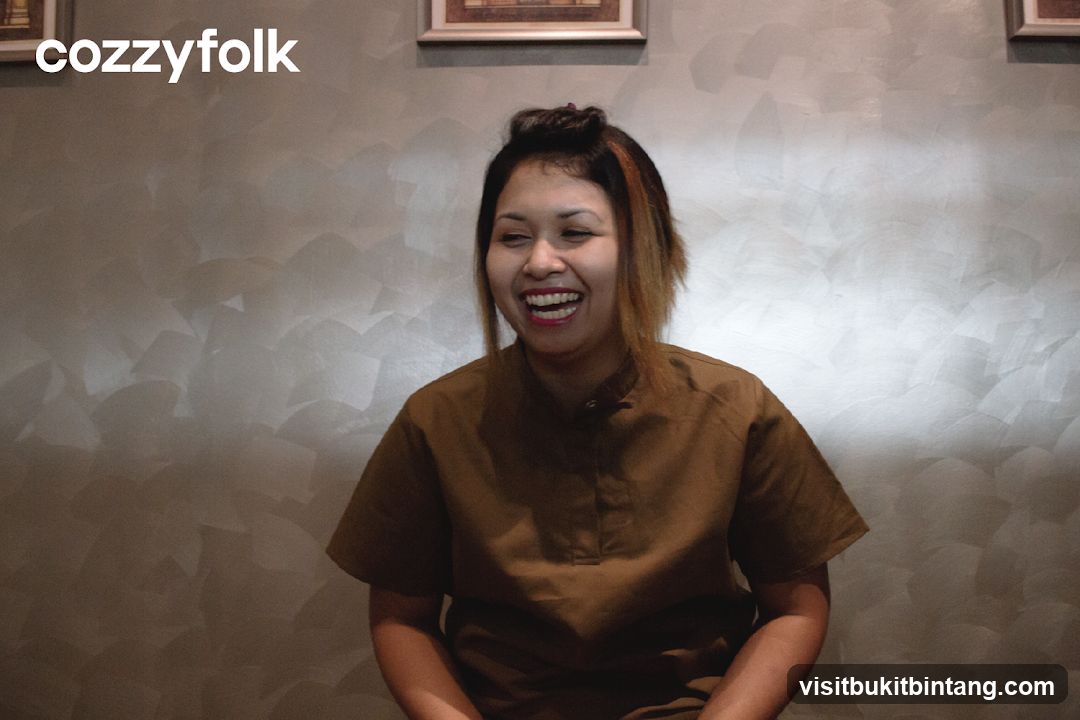 Woman laughing in front of textured wall