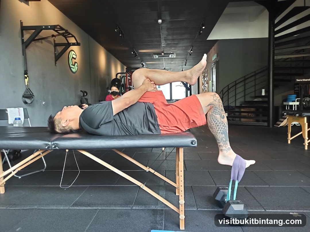 Man stretching on a table in a gym