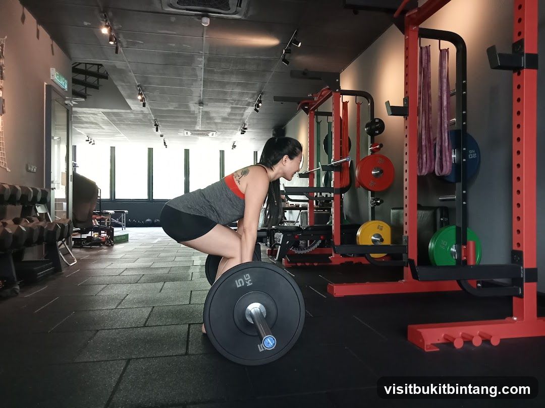 Woman performing a deadlift in a gym