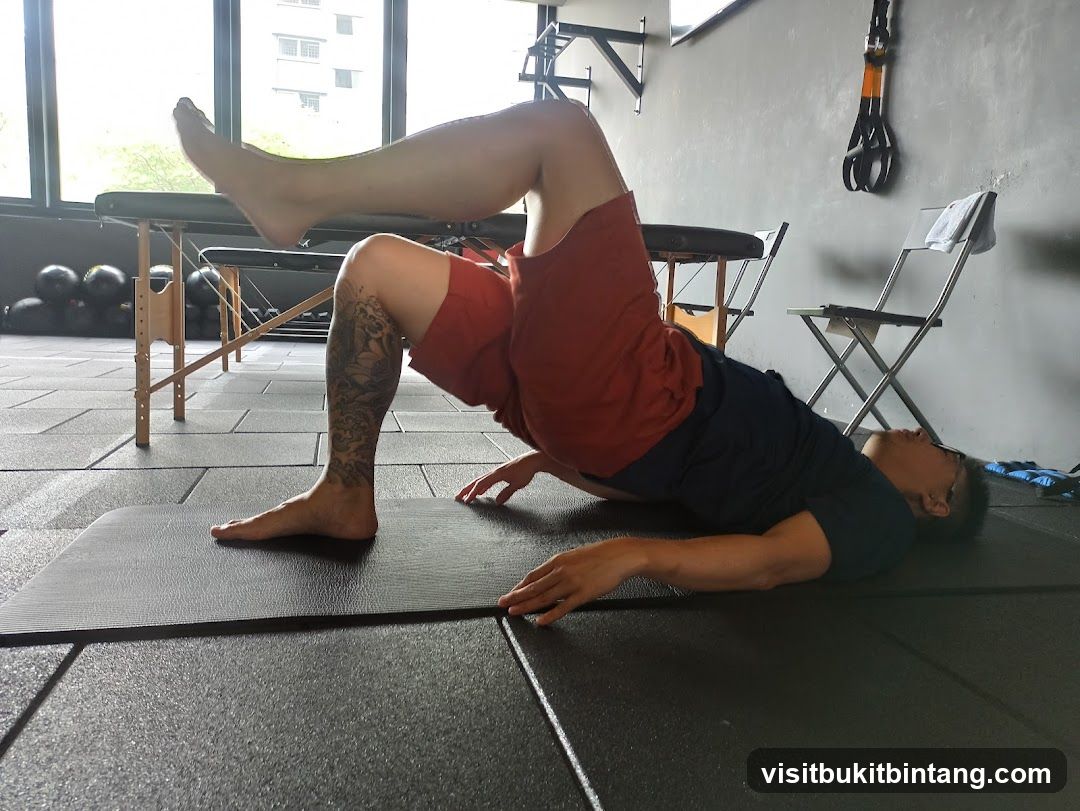 Man performing a glute bridge exercise
