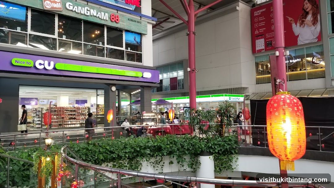 Indoor shopping mall with various shops and decorations