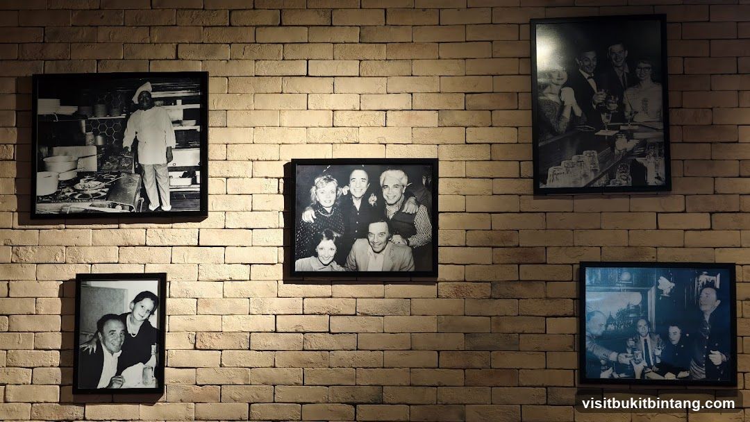 Framed photographs on a brick wall