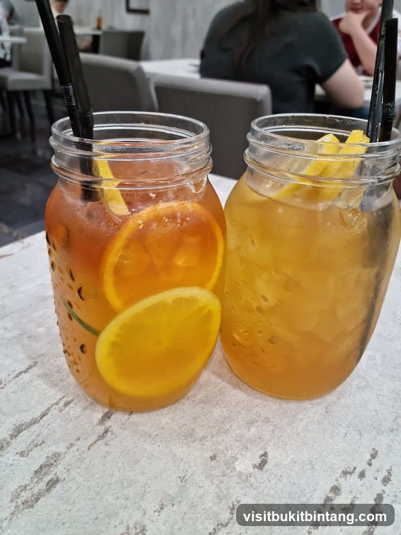 Two iced drinks with fruit
