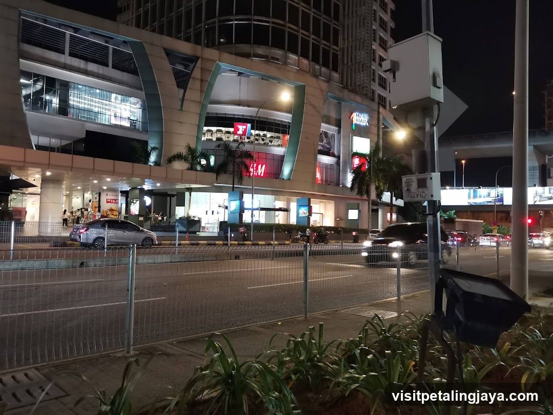 Night street scene with shopping mall exterior