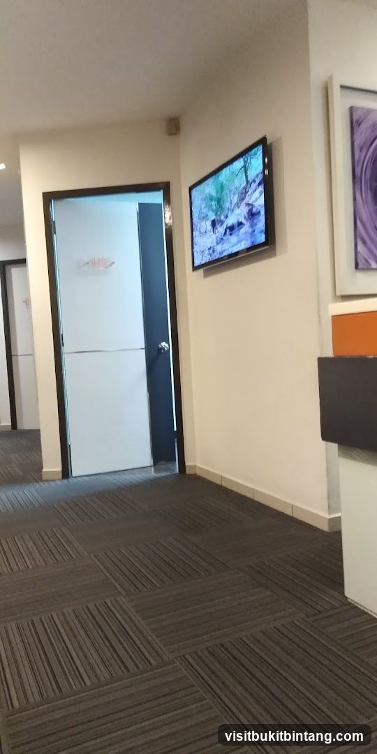 Hallway with a door and a TV