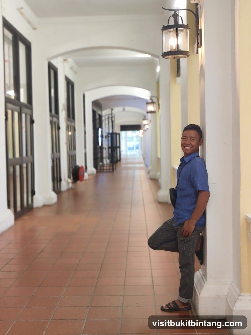 Man leaning against a pillar in a covered walkway